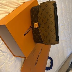 Pochette Métis Bag .Monogram Reverse Canvas features a signature S -lock